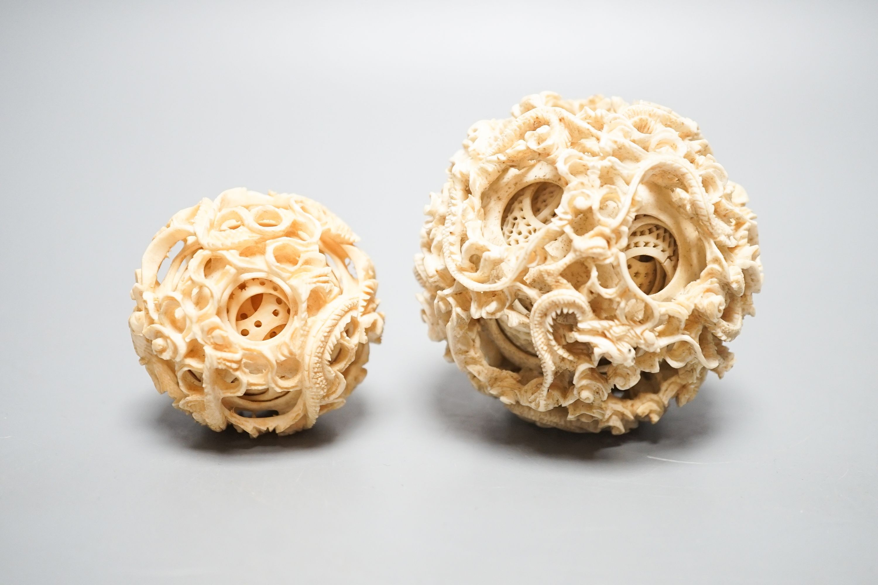 Two Chinese concentric ivory puzzle balls, first half 20th century, largest 8.6cm